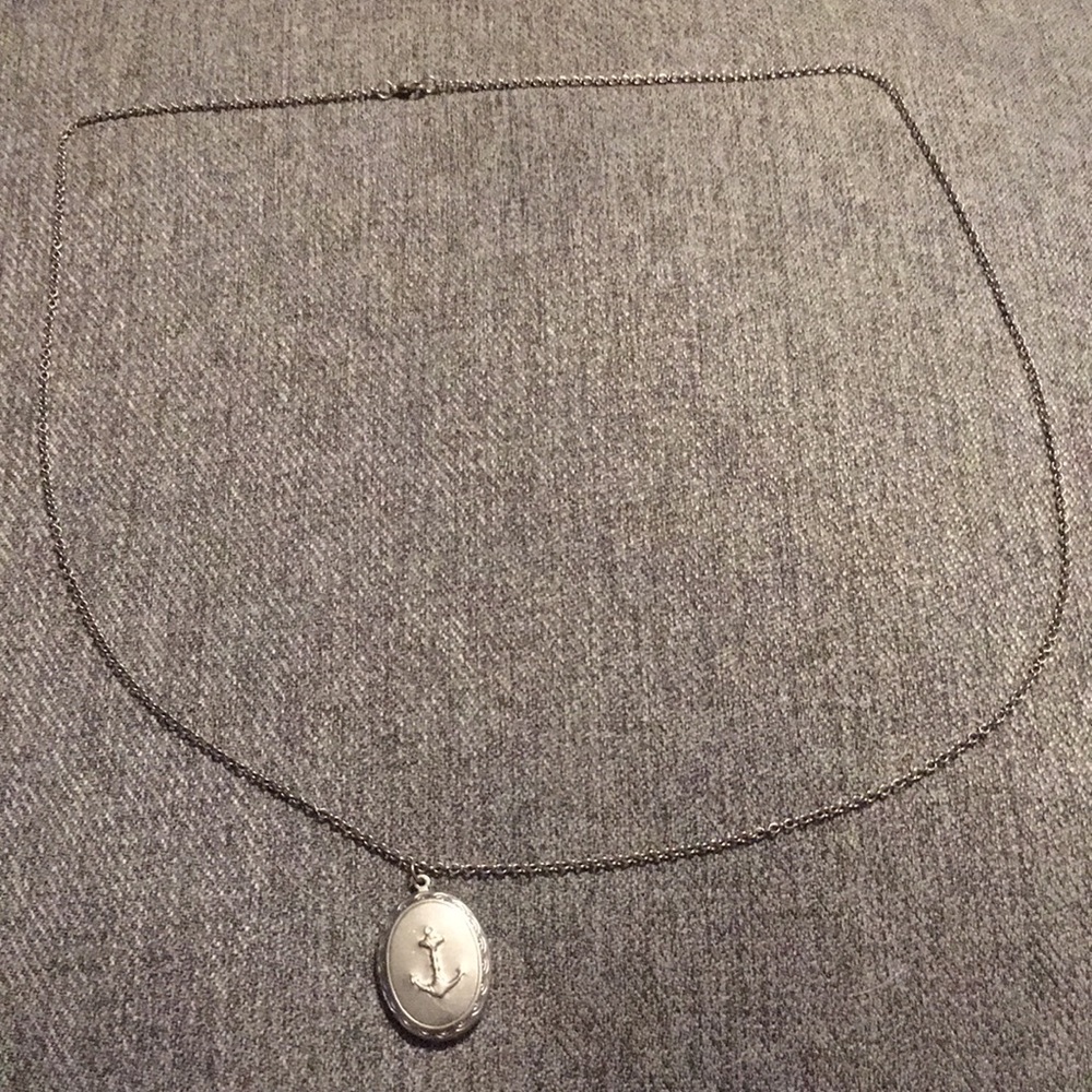Silver anchor locket lightly worn